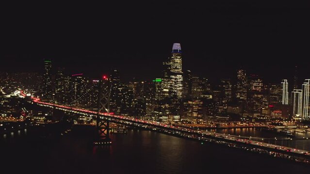 Aerial slider shot of San Francisco skyscrapers from the bay bridge at night