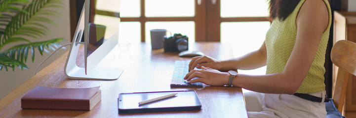 Hand embroidery concept, Women is typing and working on computer about handicraft of embroidery