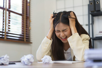 Secretary concept, Female secretary screaming and put hands on head while stressed with mistake job