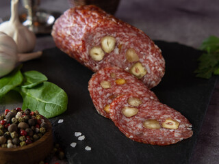 Sliced sausage with olives, on a cutting board