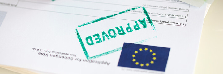 Approved EU visa application and cash euro banknotes