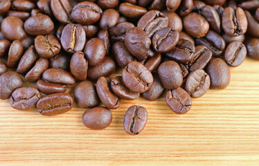 Heap of Roasted Coffee Beans on Wooden Background