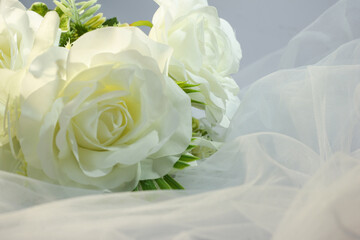 Fake white rose bouquet, tulle on table, rose fabric texture, artificial rose bouquet, romatic, valentine, wedding flower.
