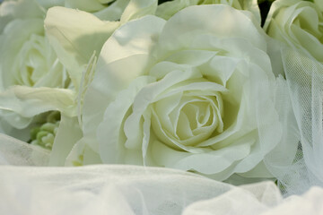 Fake white rose bouquet, tulle on table, rose fabric texture, artificial rose bouquet, romatic, valentine, wedding flower.