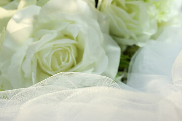 Fake white rose bouquet, tulle on table, rose fabric texture, artificial rose bouquet, romatic, valentine, wedding flower.