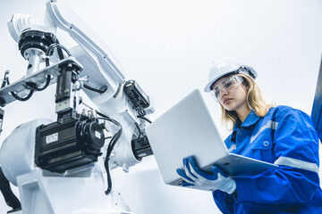 engineer woman worker working with robotic arm in productions lab research industry factory