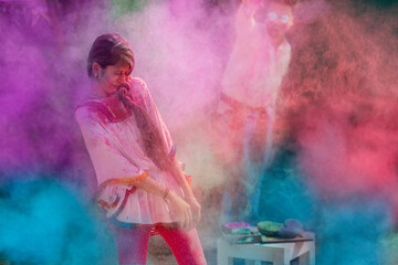 Happy young couple celebrating holi