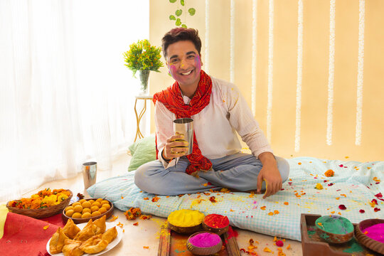 A young man holding drinking bhang on holi festival