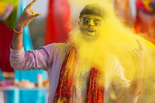 man celebrating holi with dry color