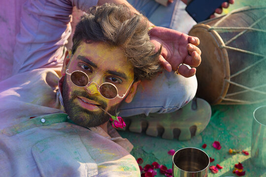 two young men enjoying holi festival together with bhang 