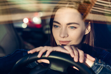 Nice young lady happy car. Image beautiful young woman who drives car and smiles. Portrait of a steering car with a driver of a happy woman with a seat belt - obrazy, fototapety, plakaty