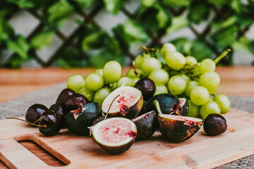 Grapes and figs on board, fresh fruit or Appetizers table in Mexico Latin America