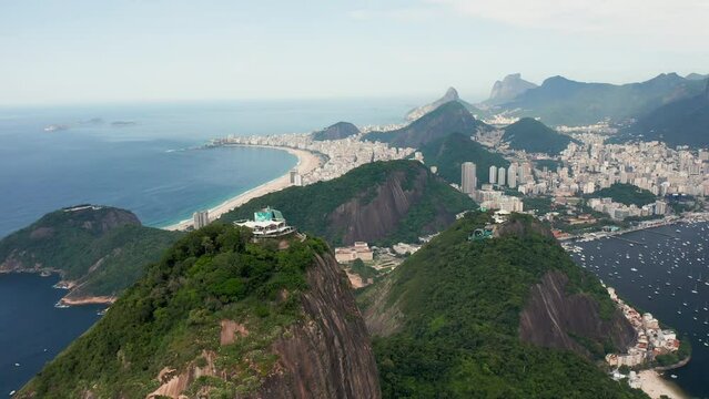 Flying backwards above top of Sugarloaf Mountain and panorama of Rio de Janeiro
