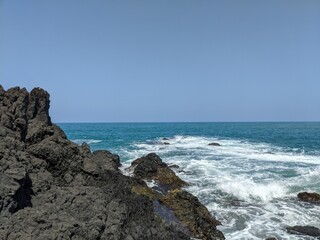 waves crashing on rocks with the sean in the backgroun in veracruz, mexico, landcape, holidays in latinoamerica