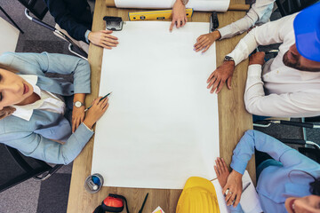 Architects, designers and engineers having working meeting in modern office