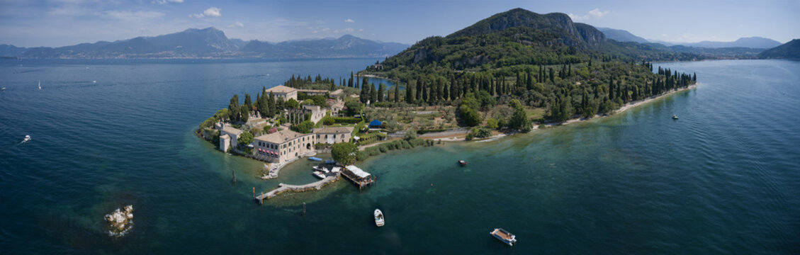 Aerial panorama of Parco San Vigilio, Lake Garda, Italy. Top view of Baia delle Sirene Park.