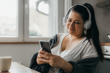 Caucasian plus size woman enjoys listening to music