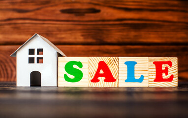 Wooden home and text on the cubes sale
