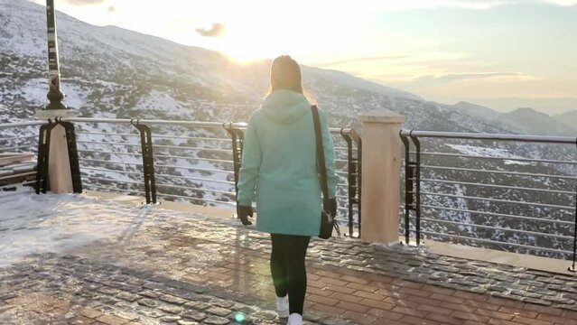 Tracking Shot Of A Woman Walking Toward A Fence Overlooking The Snowy Sierra Nevada, Spain