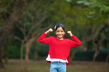 Indian little girl giving expression at park.