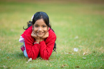 Indian little girl giving expression at park.