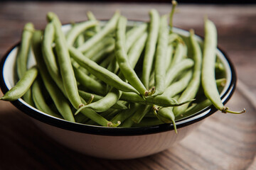 Bowl of  Raw Green Beans on wooden table in Mexico Latin America