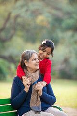Indian little girl with her grandmother at park.