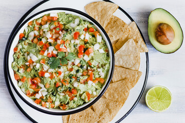Bowl of mexican guacamole with fresh ingredients in Mexico Latin America top view 