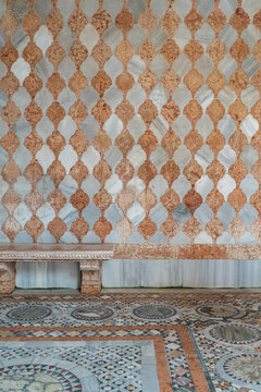 Venice Architectural detail with ancient marble mosaic wall. A Cosmatesque art of geometric decorative inlay stonework typical of the architecture of Venetian Gothic, Italy