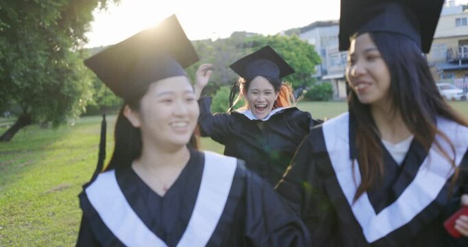 Excited female graduate about to embrace friend