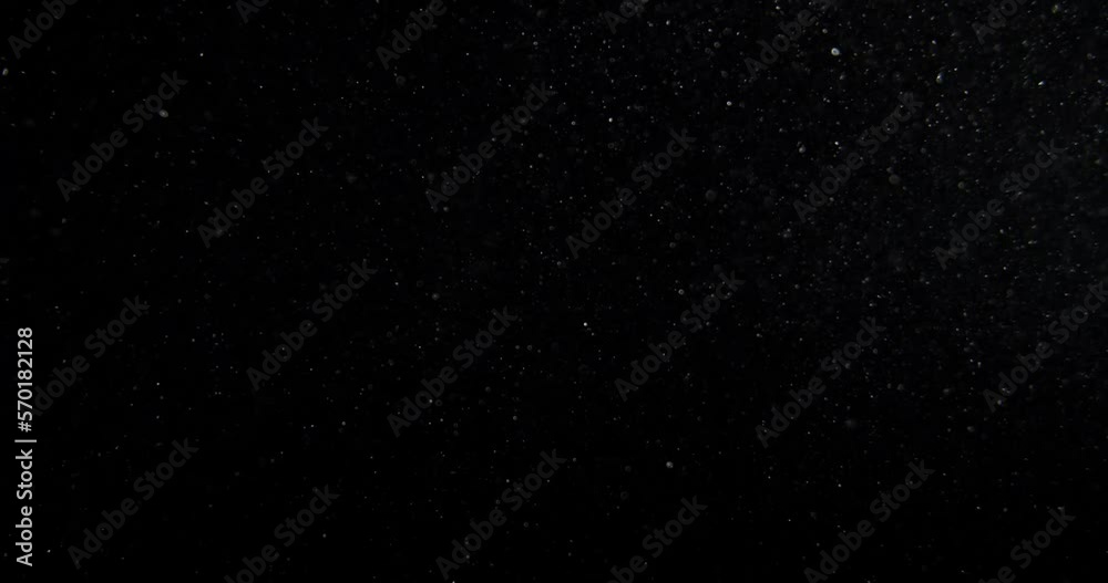 Poster vertical dust particles system floating on black screen overlay. red camera footage in slow motion. 