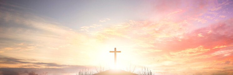 The cross of God in the rays of the sunset background