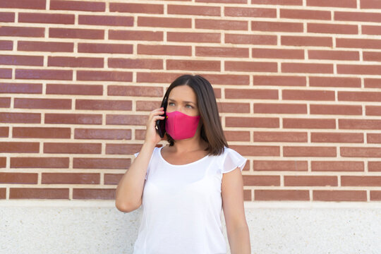 beautiful woman with mask talking on her smartphone