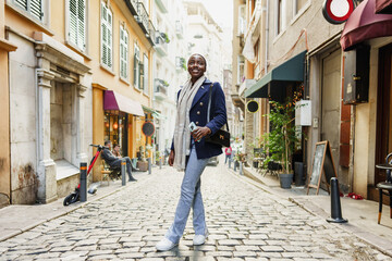 Fototapeta na wymiar Young african woman walks alone on europe street