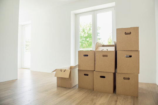 Cardboard boxes pile stack new home empty room