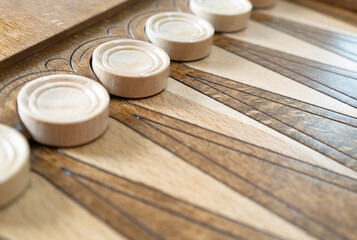 Closeup of backgammon board game. Wooden backgammon board with checkers and dice pair