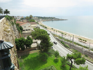 Tarragona, Spain - 06,07,2022: A view of the coast of Tarragona, in Spain, and its Passeig Maritim promenade near Mediterranean Sea