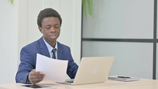 African Businessman Feeling Upset after Reading Documents, Paperwork