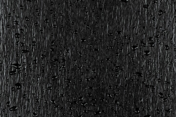 Fototapeta premium Water drops on dark stone