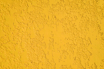 Close-up, the texture of the facade of decorative yellow plaster.