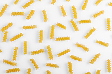 Pasta products in the form of a spiral, texture, on a white background