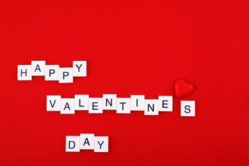 inscription Valentine's day and red hearts on a red background