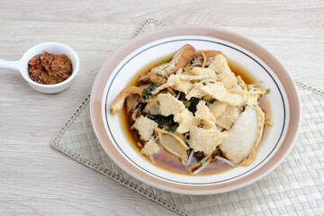 Mie Kopyok, a traditional noodle from Semarang, Central Java, Indonesia. Noodle mixed with lontong (rice cake), tofu, bean sprouts, leeks and crackers. Served with sambal (chilli sauce).

