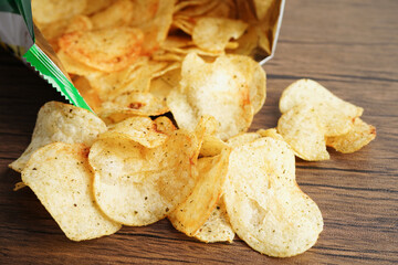 Potato chips in open bag, delicious BBQ seasoning spicy for crips, thin slice deep fried snack fast food in open bag.