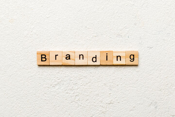 branding word written on wood block. branding text on table, concept