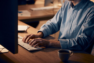 Hands, businessman and computer typing at night for planning, data analysis and internet. Closeup of keyboard, desktop technology and worker at table in dark office for seo research, website or email