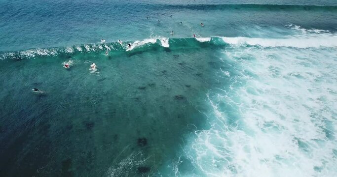 Drone shot of people surfing in sea