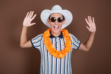 Cheerful young man in a hat and sunglasses. Long awaited vacation. Joyful emotions. Copy Space.