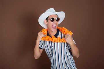 Cheerful young man in a hat and sunglasses. Long awaited vacation. Joyful emotions. Copy Space.