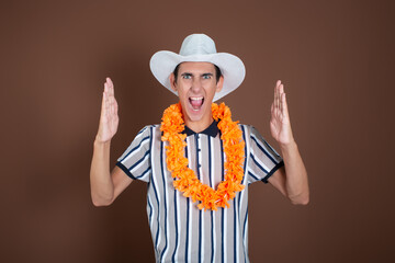 Cheerful young man in a hat and sunglasses. Long awaited vacation. Joyful emotions. Copy Space.